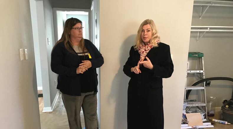 Ingrid Buxbaum, right, stands in a home she is renovating in the Starlight Heights neighborhood in DeKalb County on Jan. 16, 2019, and speaks to neighbor Debbie Joudeh about concerns they have about the park land swap proposed by Blackhall Studios. (TIA MITCHELL/TIA.MITCHELL@AJC.COM)