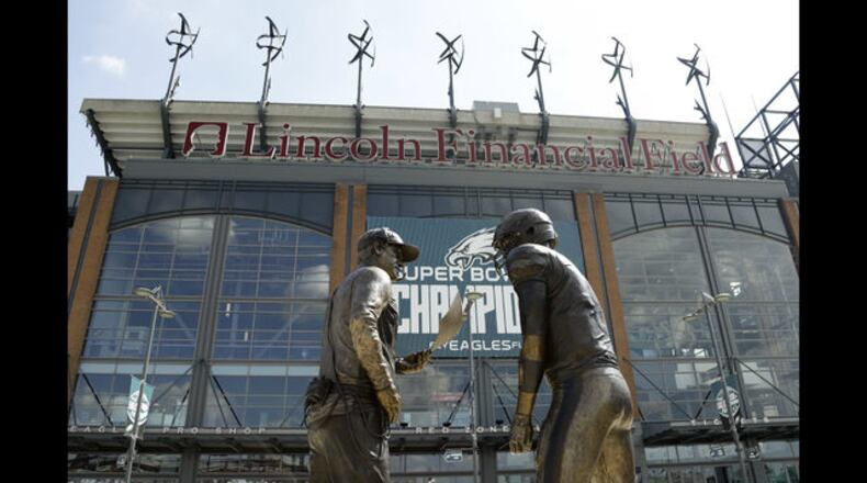 A nine-foot bronze statue depicting Philadelphia Eagles quarterback Nick Foles, right, and head coach Doug Pederson discussing the "Philly Special" trick play is seen at Lincoln Financial Field, Wednesday, Sept. 5, 2018, in Philadelphia. The statue, unveiled by Bud Light, highlights the famous play from the Philadelphia Eagles' 41-33 win over the New England Patriots in Super Bowl 52. (AP Photo/Matt Slocum)