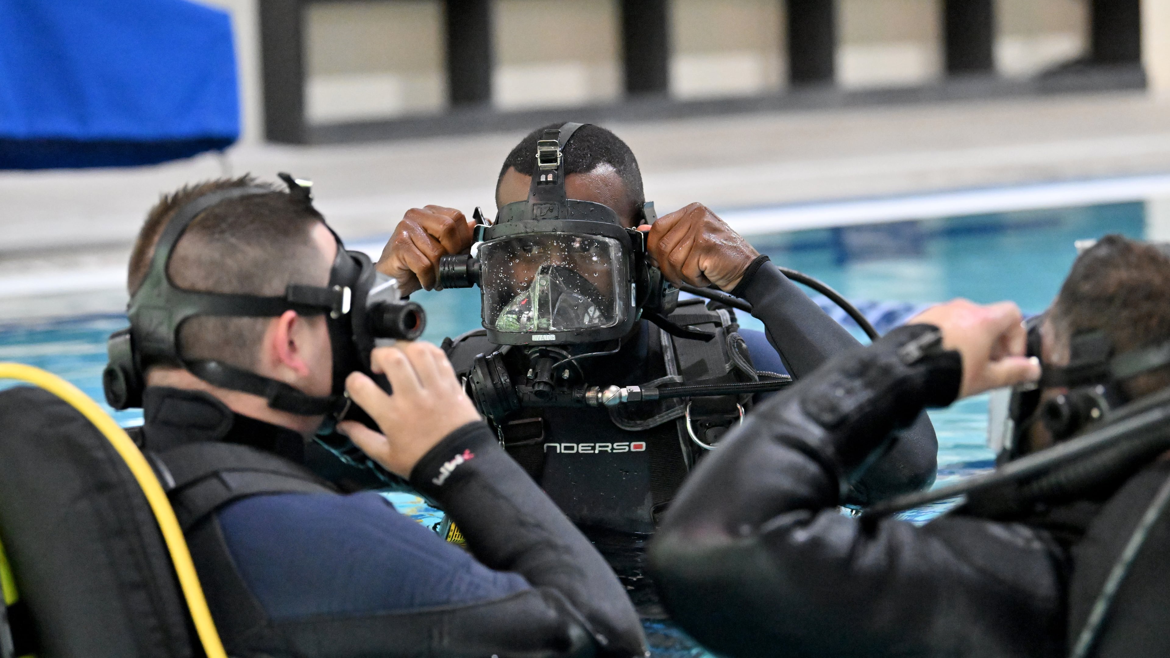 Anthony Oliver (center) of the Hall County Sheriff's Office's dive team instructs Tyler Guthrie (left) and Michael Mitchell during a recent training session. (Hyosub Shin / AJC)