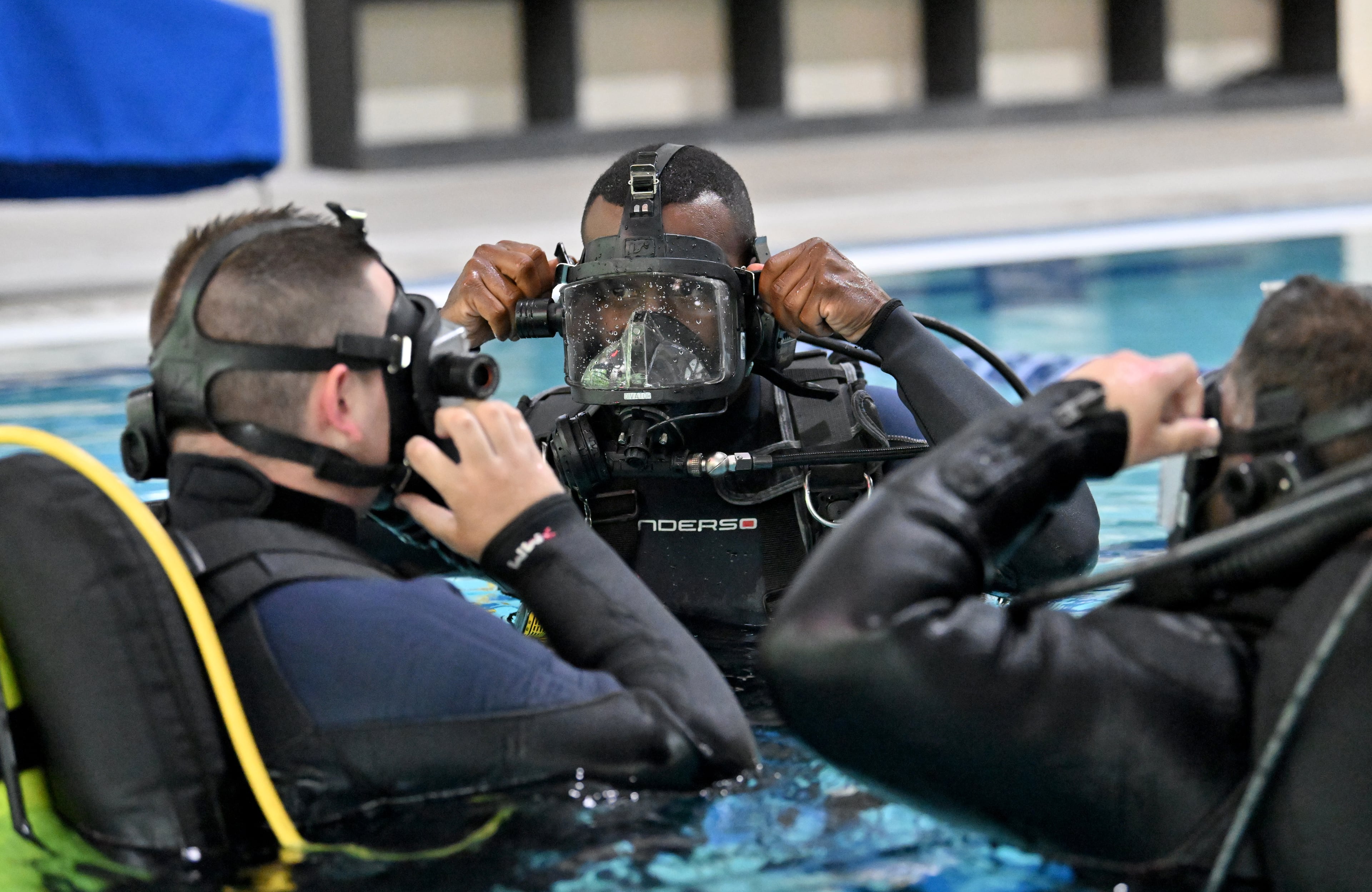 Anthony Oliver (center) of the Hall County Sheriff's Office's dive team instructs Tyler Guthrie (left) and Michael Mitchell during a recent training session. (Hyosub Shin / AJC)