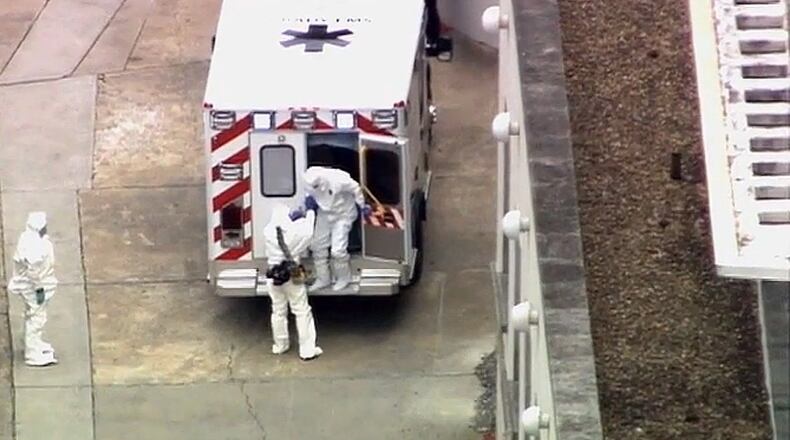 An ambulance arrives with Ebola victim Dr. Kent Brantly, right, at Emory University Hospital, Saturday. WSB-TV photo.