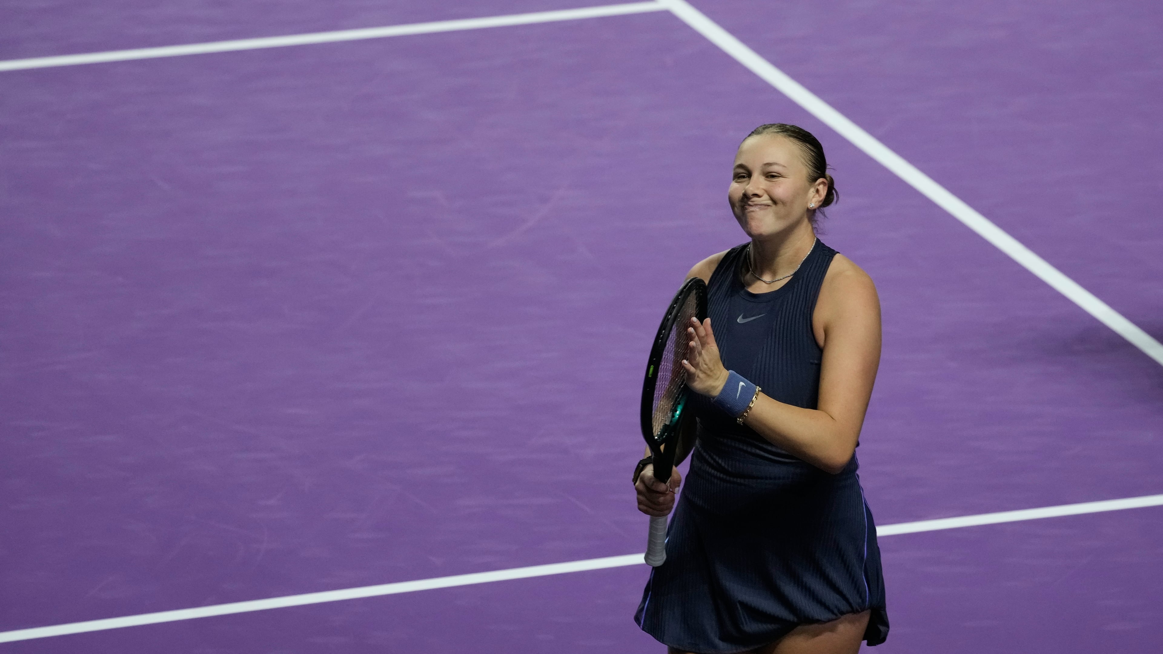 Amanda Anisimova of the United States celebrates after winning her women's singles match against Iga Swiatek of Poland at the WTA tennis finals in Riyadh, Saudi Arabia, Wednesday, Nov. 5, 2025. (AP Photo/Fatima Shbair)