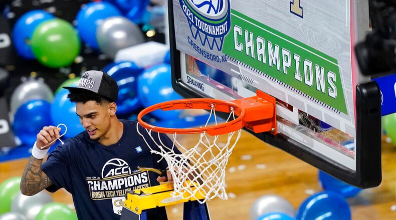 Georgia Tech guard Michael Devoe (0) holds his piece of the net as he celebrates his team's 80-75 win over Florida State in the Championship game of the Atlantic Coast Conference tournament in Greensboro, N.C., Saturday, March 13, 2021. (AP Photo/Gerry Broome)