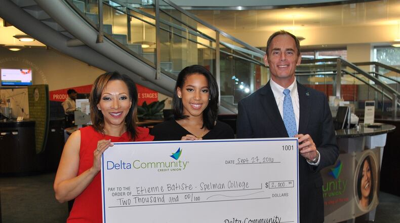 Etienne with KISS 104 radio personality Veronica Waters and Delta Community Credit Union CEO Hank Halter.