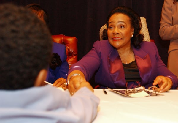 In this 2005 photo, a four-year old admirer shakes the hand of Coretta Scott King during a book signing session held at the King Center Sunday afternoon. Late into life, Coretta continued to be the public face of the King family and the keeper of her husband's legacy. (BILLY SMITH II/AJC staff)