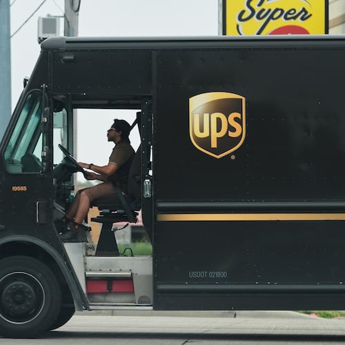 A UPS truck driver makes a delivery Wednesday, June 25, 2025, in River Forest, Ill. The first 2,000 retrofitted vehicles with AC are set to be ready by June 1, 2026, with all 5,000 to be finished by June 1, 2027, the Teamsters union said. (Nam Y. Huh/AP)