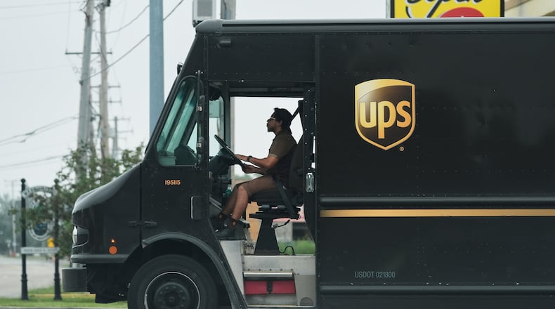 A UPS truck driver makes a delivery Wednesday, June 25, 2025, in River Forest, Ill. The first 2,000 retrofitted vehicles with AC are set to be ready by June 1, 2026, with all 5,000 to be finished by June 1, 2027, the Teamsters union said. (Nam Y. Huh/AP)