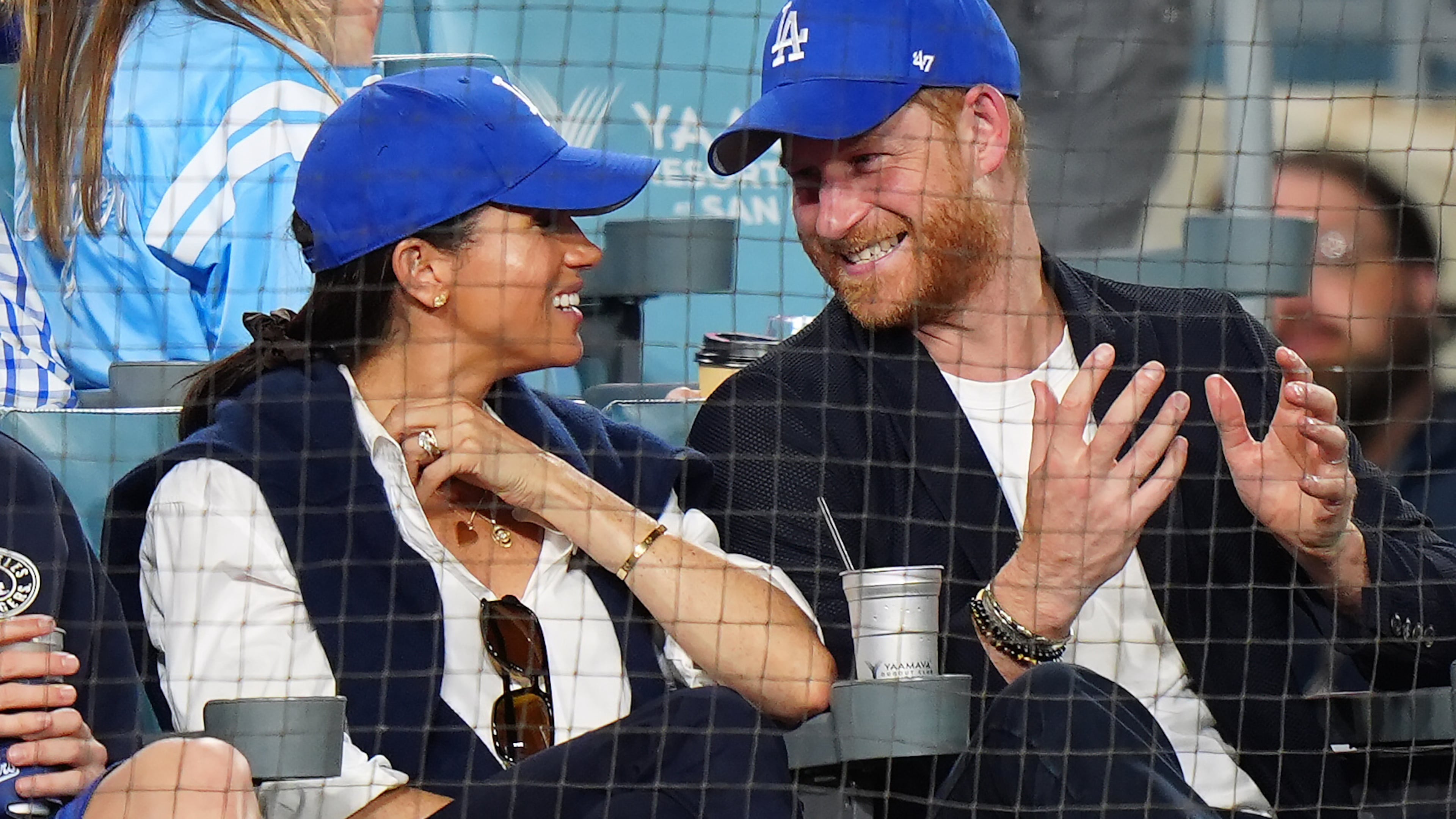 Prince Harry, right, and Meghan Markle, Duke and Duchess of Sussex, sit during the eighth inning in Game 4 of baseball's World Series between the Los Angeles Dodgers and the Toronto Blue Jays in Los Angeles, Tuesday, Oct. 28, 2025. (Frank Gunn/The Canadian Press via AP)