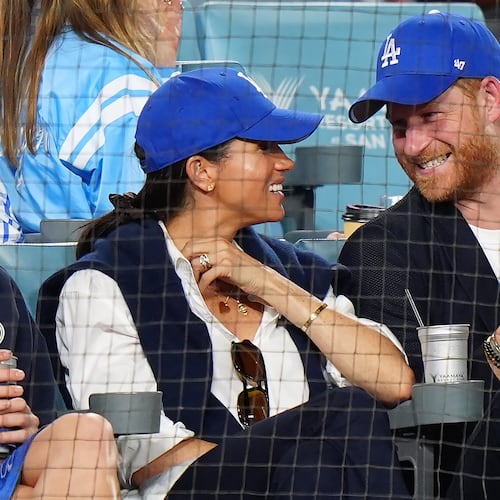 Prince Harry, right, and Meghan Markle, Duke and Duchess of Sussex, sit during the eighth inning in Game 4 of baseball's World Series between the Los Angeles Dodgers and the Toronto Blue Jays in Los Angeles, Tuesday, Oct. 28, 2025. (Frank Gunn/The Canadian Press via AP)
