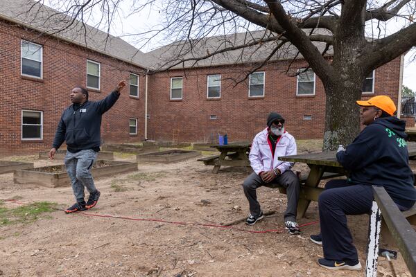 Volunteers with C.H.O.I.C.E.S mobile food pantry take a break in front of the Fulton County Oak Hill Child, Adolescent & Family Center in Atlanta on Friday, February 10, 2023. The complex will become home to a county behavioral crisis center. (Arvin Temkar / arvin.temkar@ajc.com)