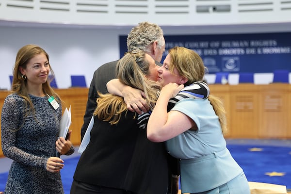 Agent to the European Court of Human Rights for the Government of the Kingdom of the Netherlands Babette Koopman, right, hugs plaintiffs after the European Court of Human Rights issued its judgment on Russian violations in Ukraine since 2014, including the downing of Malaysia Airlines flight MH17, Wednesday, July 9, 2025 in Strasbourg, eastern France. (AP Photo/Antonin Utz)