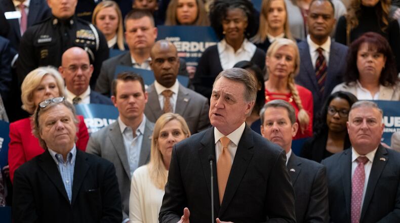 U.S. Sen. David Perdue of Georgia, flanked by supporters, speaks to the media after qualifying to run for a second term on March 2. BenGray.com/Special