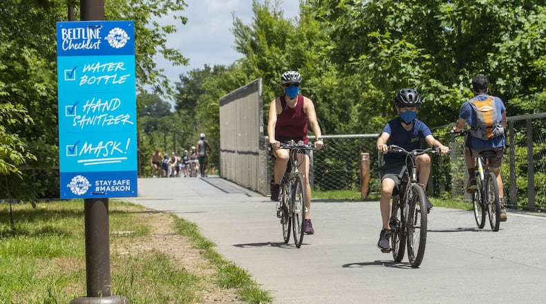 Aleta Mills-Stubin, left, and her son Marcus ride their bicycles along the Atlanta Beltline Eastside Trail in Atlanta in July. (ALYSSA POINTER / ALYSSA.POINTER@AJC.COM)