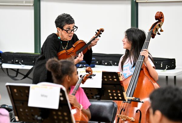 Juana Alzaga instructs a member of the Buford Highway Orchestra Project at the Latin American Association on Thursday, Nov. 6, 2025, in Brookhaven. (Hyosub Shin/AJC)