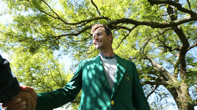 Adam Scott, the 2013 Masters champion, sports his green jackets and shakes hands with fans under the giant oak tree by the clubhouse arriving for the Masters at Augusta National Golf Club on Sunday, April 3, 2016, in Augusta. Curtis Compton / ccompton@ajc.com