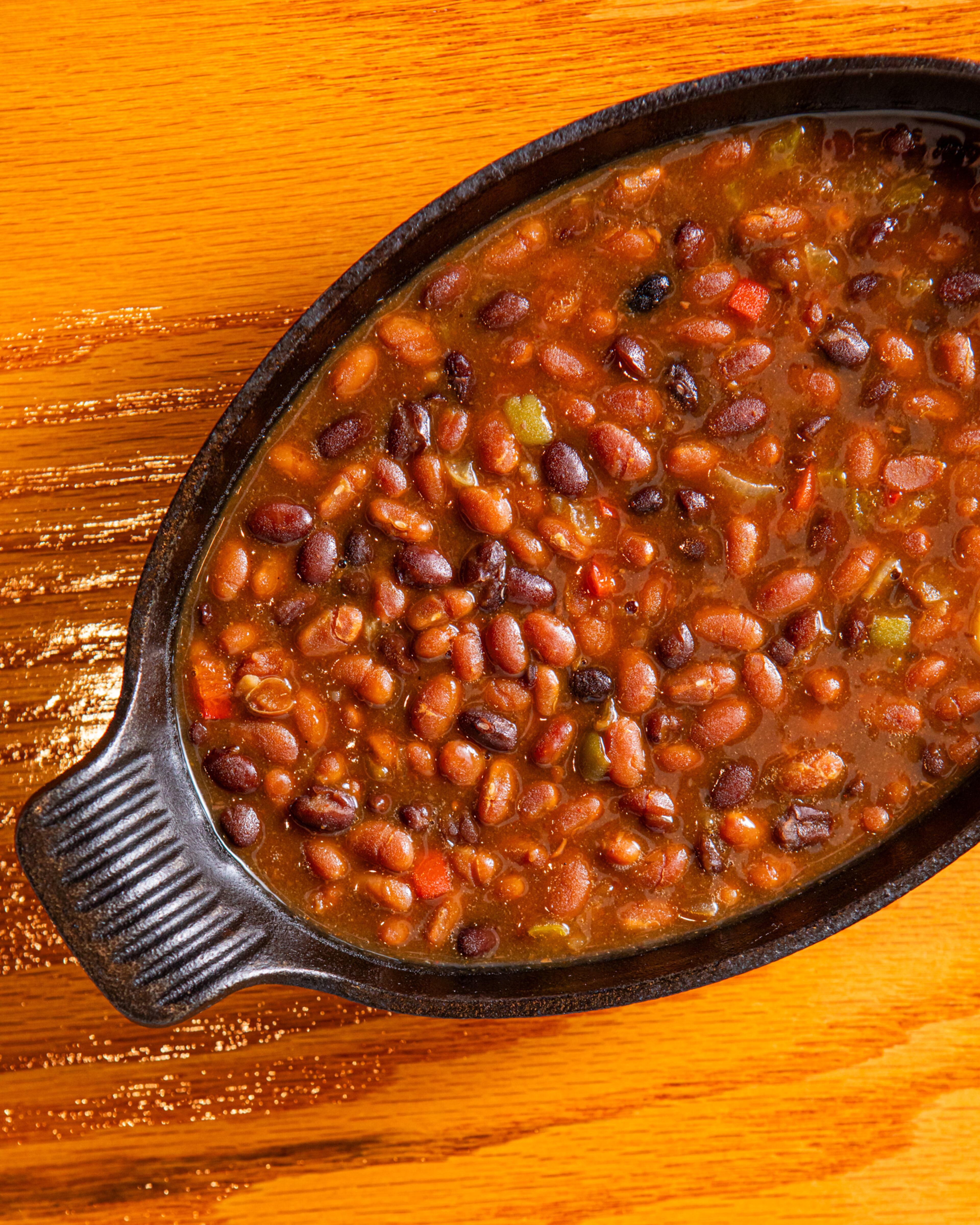 Michele Tomkins' home cook recipe for Two Bean Baked Beans uses grocery store ingredients that come together quickly. (Aaliyah Man for the AJC/food styling by Michele Tomkins)