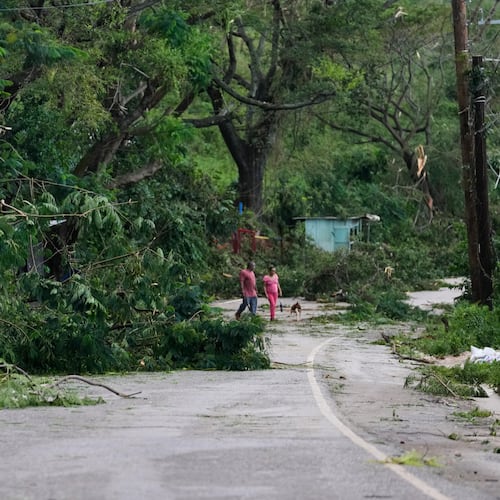 People walk along a road after Hurricane Melissa passed through Spurr Tree, Jamaica, Wednesday, Oct. 29, 2025. (AP Photo/Matias Delacroix),