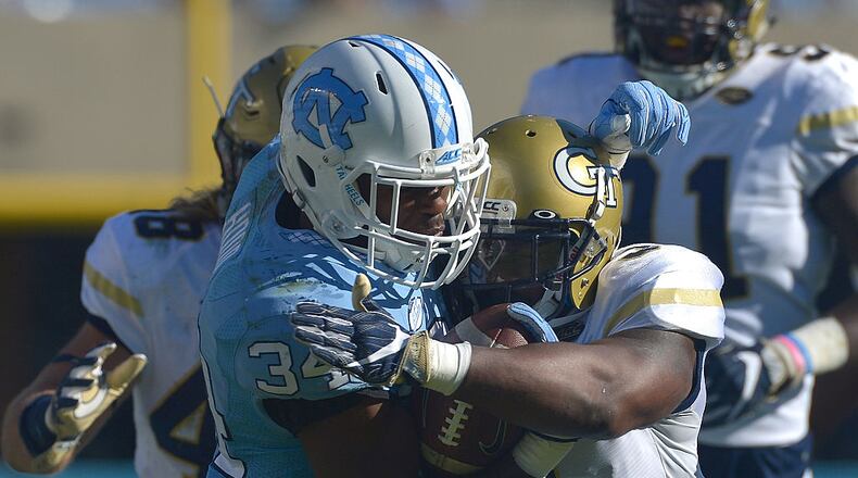 CHAPEL HILL, NC - NOVEMBER 05:  Victor Alexander #9 of the Georgia Tech Yellow Jackets tackles Elijah Hood #34 of the North Carolina Tar Heels during the game at Kenan Stadium on November 5, 2016 in Chapel Hill, North Carolina. North Carolina won 48-20.  (Photo by Grant Halverson/Getty Images)