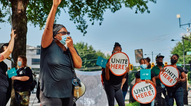Led by the United Food and Commercial Workers union, demonstrators on Friday outside the Atlanta office of Sen. David Perdue calling on him to support hazard pay for front-line workers.