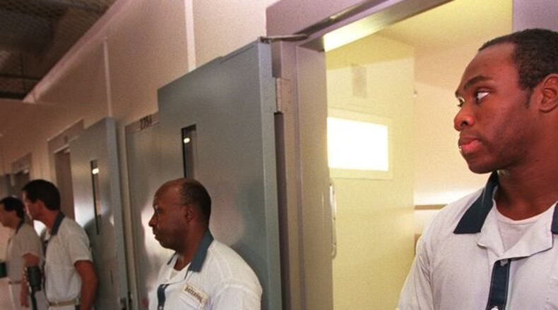 This 1999 file photo shows prisoners lining up for security checks inside Smith State Prison