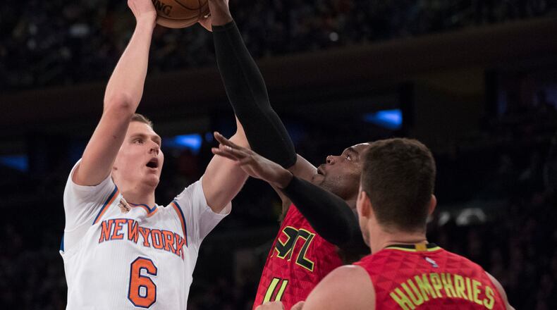 New York Knicks forward Kristaps Porzingis (6) goes to the basket against Atlanta Hawks forward Paul Millsap (4) and forward Kris Humphries (43) during the first half of an NBA basketball game, Sunday, Nov. 20, 2016, at Madison Square Garden in New York. (AP Photo/Mary Altaffer)