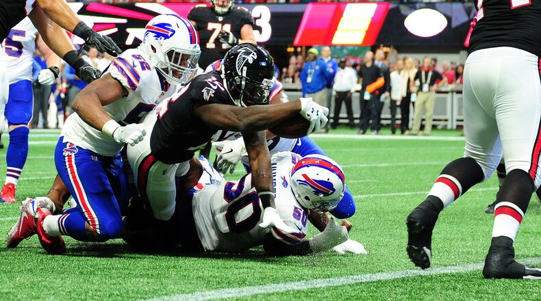 Falcons wide receiver Mohamed Sanu reaches for extra yardage during the first half against the Bills at Mercedes-Benz Stadium on October 1 in Atlanta.