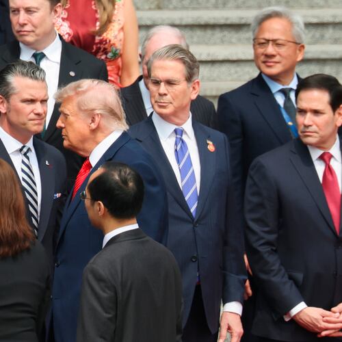 U.S. President Donald Trump looks on next to, from bottom right, U.S. Secretary of State Marco Rubio, U.S. Treasury Secretary Scott Bessent, U.S. Defense Secretary Pete Hegseth, Nvidia CEO Jensen Huang, top right, Tesla CEO Elon Musk, Apple CEO Tim Cook, top left, and others during a welcome ceremony at the Great Hall of the People in Beijing, Thursday, May 14, 2026. (Maxim Shemetov/Pool Photo via AP)