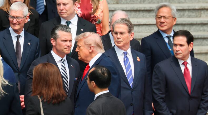 U.S. President Donald Trump looks on next to, from bottom right, U.S. Secretary of State Marco Rubio, U.S. Treasury Secretary Scott Bessent, U.S. Defense Secretary Pete Hegseth, Nvidia CEO Jensen Huang, top right, Tesla CEO Elon Musk, Apple CEO Tim Cook, top left, and others during a welcome ceremony at the Great Hall of the People in Beijing, Thursday, May 14, 2026. (Maxim Shemetov/Pool Photo via AP)
