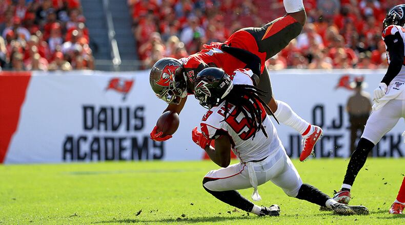 Buccaneers running back Peyton Barber is upended by the Falcons' De'Vondre Campbell in the regular season finale Sunday, Dec. 29, 2019, at Raymond James Stadium in Tampa, Fla.