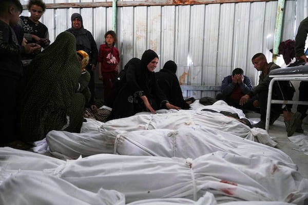 Palestinians grieve over the bodies of their relatives, who were killed in an Israeli airstrike, as they prepare for burial at a hospital in Beit Lahiya, Gaza Strip, on Wednesday, April 2, 2025. (AP Photo/Jehad Alshrafi)