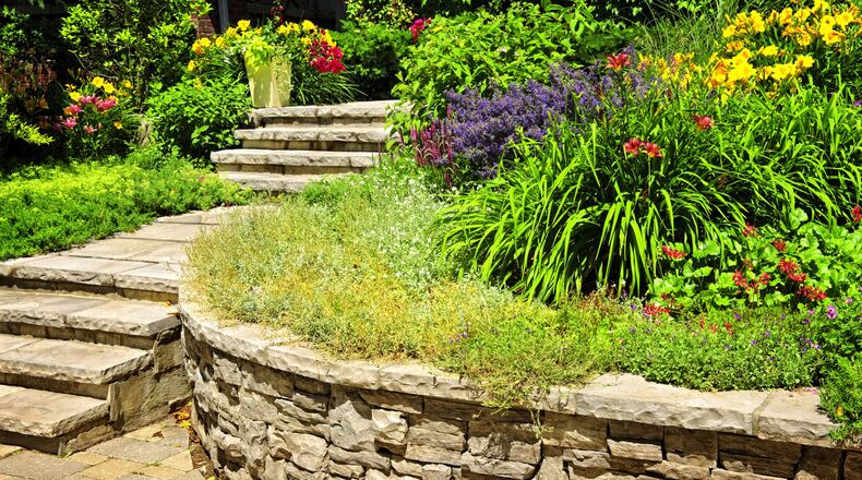 A stone retaining wall looks classic and natural particularly when it s installed by a skilled stonemason. (Dreamstime)