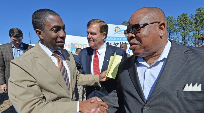 Lee May (left), at the time DeKalb County’s interim CEO, greets Stan Watson, at the time a commissioner, before an event on March 14, 2014, in Stone Mountain. HYOSUB SHIN / HSHIN@AJC.COM
