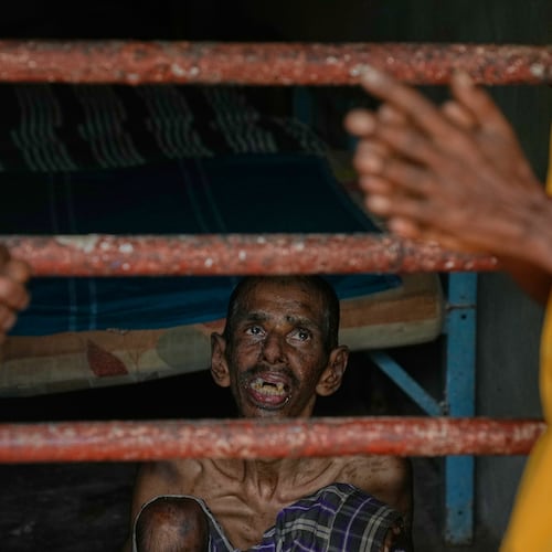 A resident looks at his family members as he sits inside his dormitory at a nursing home in Anguruwatota, Sri Lanka, Friday, June 5, 2026. (AP Photo/Eranga Jayawardena)