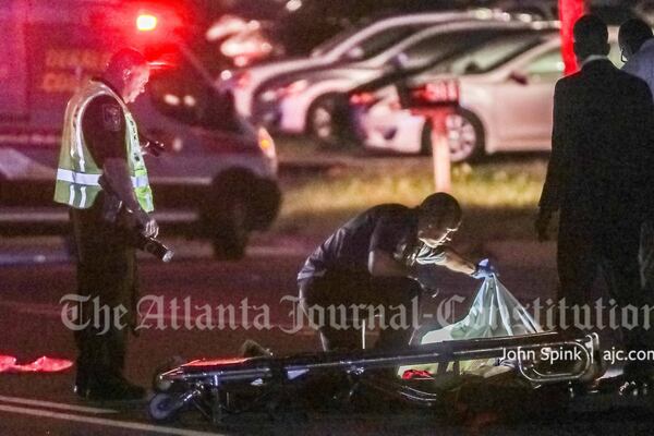 A body could be seen lying in the middle of Covington Highway during a crash investigation Wednesday morning. 
