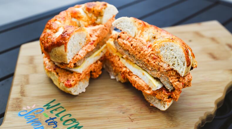 At Big Bon Bodega, you can get savory pork sausage and fluffy egg patties nestled in a cheddar cheese bagel smeared with cheddar-pimento cream cheese. (Adriana Iris Boatwright for The Atlanta Journal-Constitution)