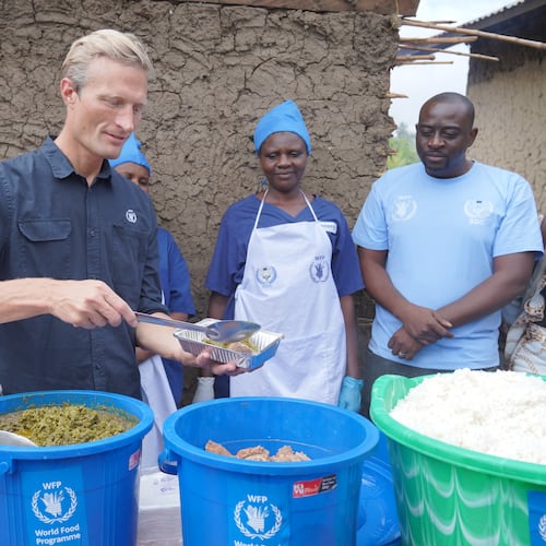 Carl Skau, acting executive director of the World Food Programme, pepares a container of food at the Rwampara Ebola treatment center in Ituri, eastern Congo, Wednesday, July 29, 2026. (AP Photo/Dieudonne Dirole)