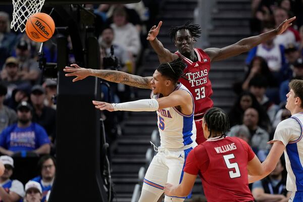 Florida guard Will Richard (5) passes around Texas Tech forward Federiko Federiko (33) during the second half in the Elite Eight of the NCAA college basketball tournament, Saturday, March 29, 2025, in San Francisco. (AP Photo/Godofredo A. Vásquez)
