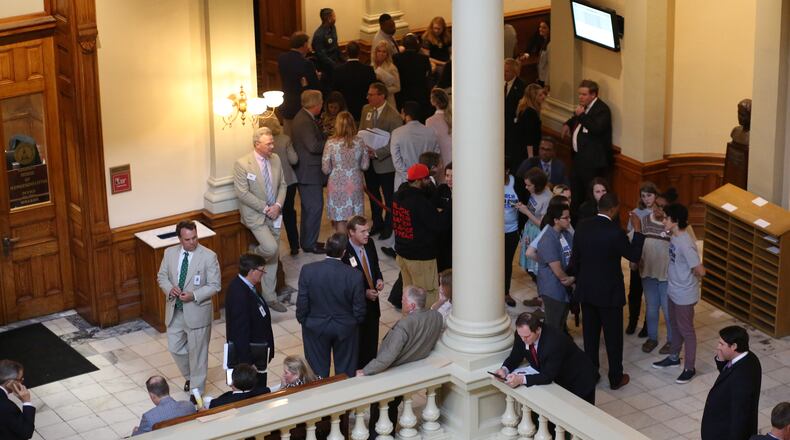 March 29, 2018 - Atlanta, Ga: Lawmakers, lobbyists, staff and other members of the public mingle outside of the House Chambers during Legislative Day 40 at the Georgia State Capitol Thursday, March 29, 2018, in Atlanta. PHOTO / JASON GETZ