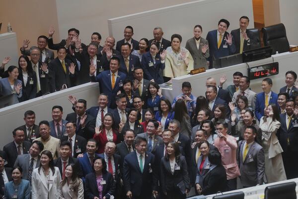 Thailand Prime Minister Paetongtarn Shinawatra, fifth right on top, reacts after a no-confidence vote against her was defeated in Bangkok, Thailand, Wednesday, March 26, 2025. (AP Photo/Sakchai Lalit)