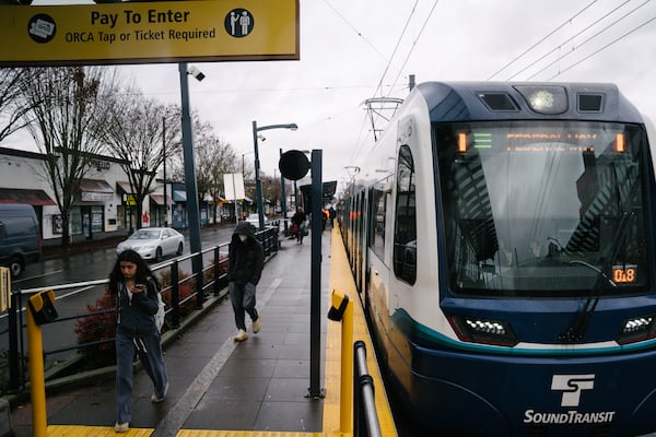 Passengers deboard a Sound Transit Link train at Othello station in Seattle in December. (Ramon Dompor for the AJC)