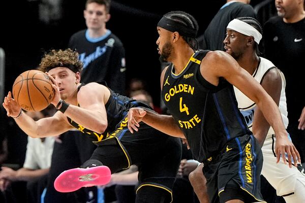 Golden State Warriors guard Brandin Podziemski (2) passes the ball against the Atlanta Hawks during the first half of an NBA basketball game, Saturday, March 22, 2025, in Atlanta. (AP Photo/Mike Stewart)