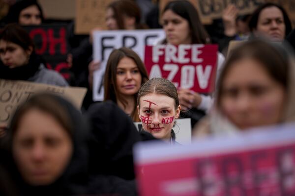 FILE - A woman with the words "Free Azov" written on her face attends a rally aiming to raise awareness on the fate of Ukrainian prisoners of war in Kyiv, Ukraine, Sunday, March 24, 2024. (AP Photo/Vadim Ghirda, File)