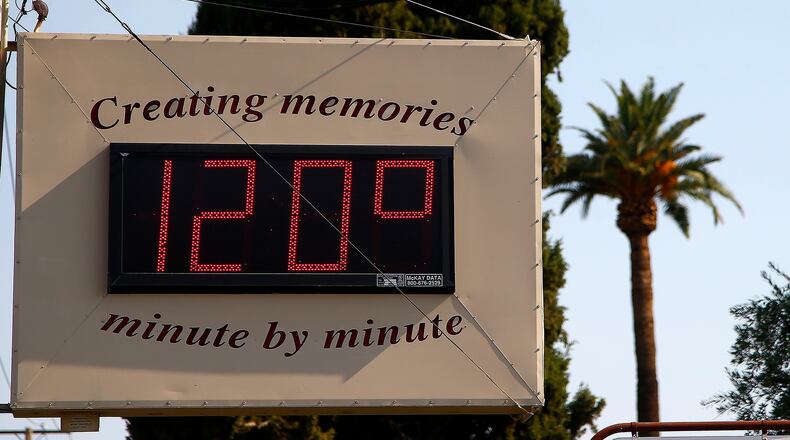 In this June file photo, a local temperature sign reads 120-degrees as temperatures climb to near-record highs in Phoenix. AP Photo/Ross D. Franklin