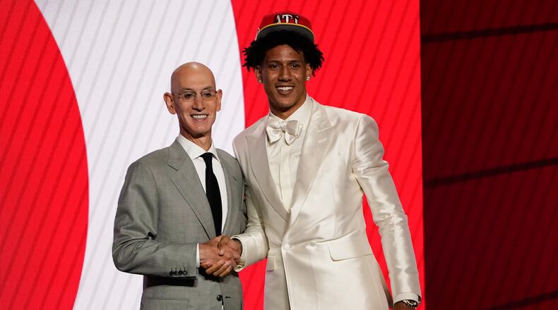Jalen Johnson poses with NBA Commissioner Adam Silver after being selected 20th by the Atlanta Hawks during the 2021 NBA draft. Who will the Hawks select with their first pick Thursday night? (AP Photo/Corey Sipkin)