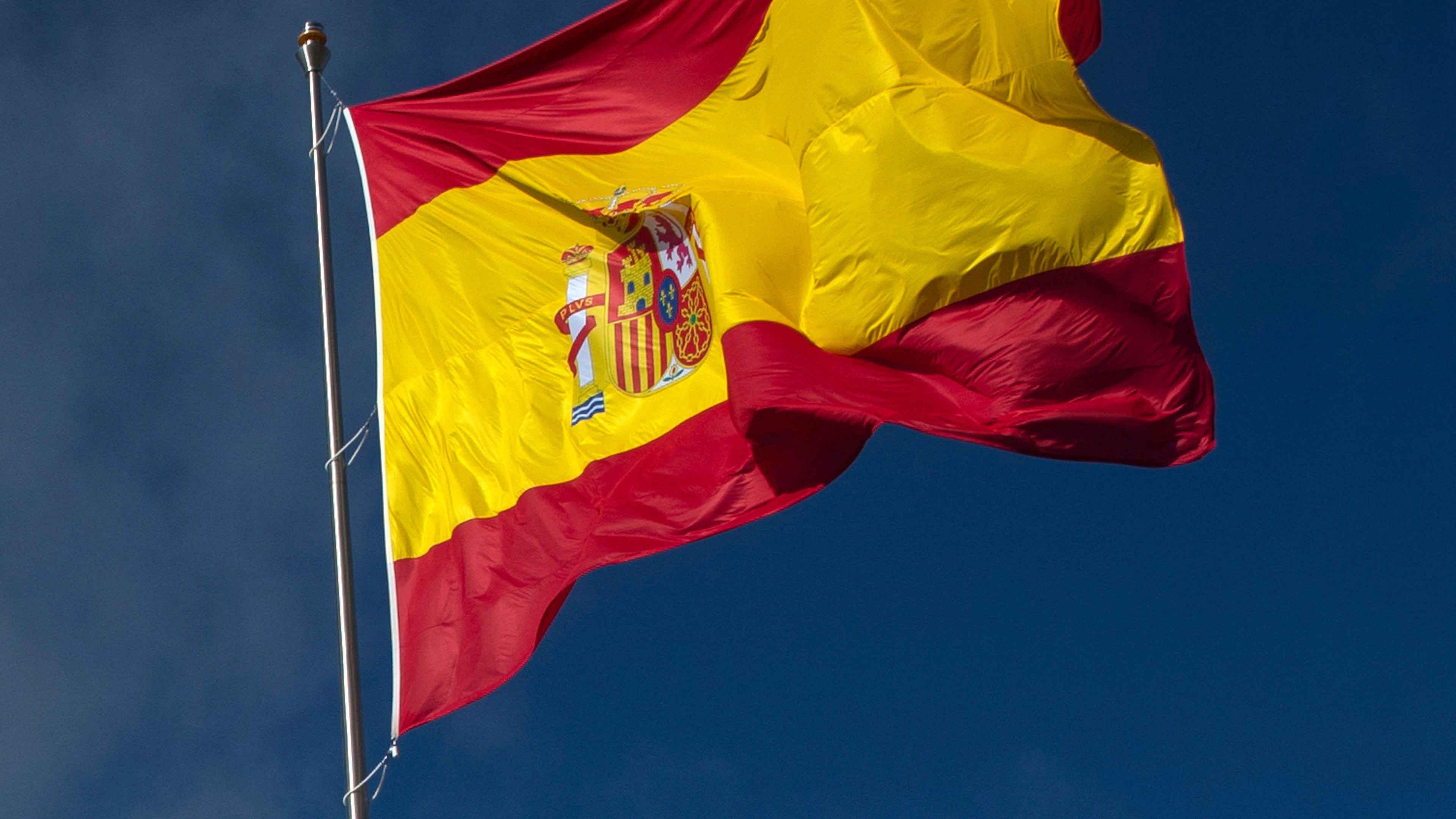 FILE - The Spanish flag flies during a memorial for coronavirus (COVID-19) victims in Madrid, Spain, Friday, Oct. 23, 2020. (AP Photo/Manu Fernandez, file)