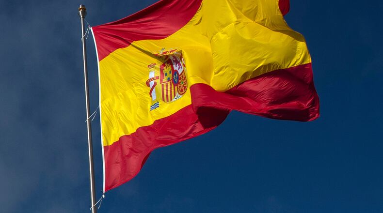 FILE - The Spanish flag flies during a memorial for coronavirus (COVID-19) victims in Madrid, Spain, Friday, Oct. 23, 2020. (AP Photo/Manu Fernandez, file)