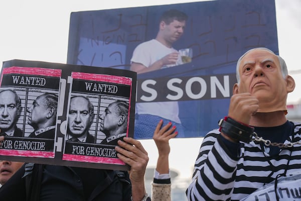 FILE - Demonstrators protest against Israeli Prime Minster Benjamin Netanyahu outside the court in Tel Aviv, where he faces corruption charges, on Dec. 10, 2024. (AP Photo/Ariel Schalit, File)
