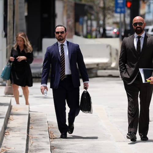 Attorney Joseph McBride, second right, representing Andrew and Tristan Tate after they were arrested to face rape and sex trafficking charges against them in the United Kingdom, arrives at the C. Clyde Atkins U.S. Courthouse, Monday, July 27, 2026, in Miami. (AP Photo/Rebecca Blackwell)