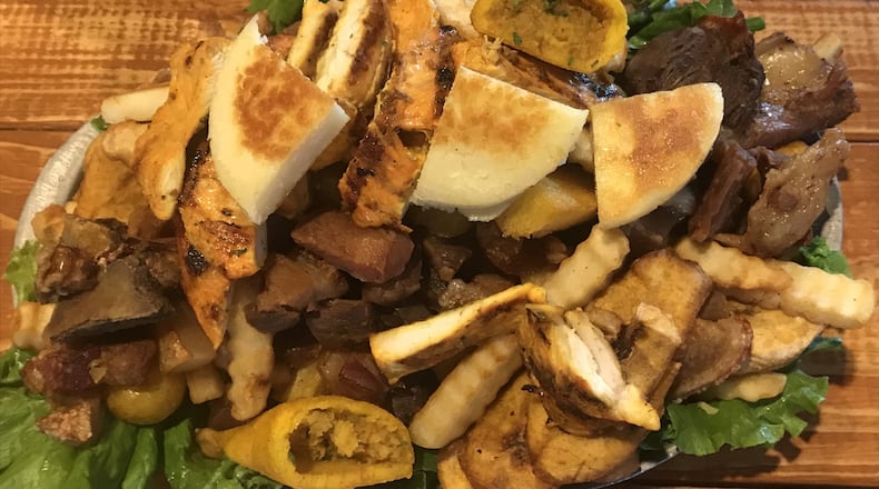 Picada de la Abuela offers a mountain of meat that will please a tableful of hungry carnivores. LIGAYA FIGUERAS / LFIGUERAS@AJC.COM