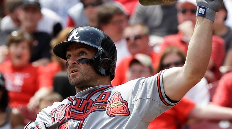 Braves second baseman Dan Uggla hits his second homer of the game in the sixth inning off Reds pitcher Mike Leake.